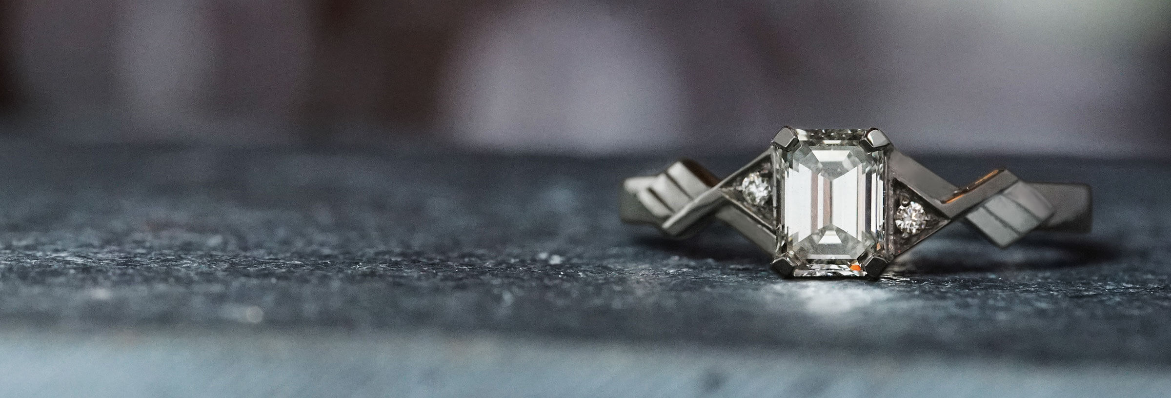 Platinum art deco inspired emerald cut diamond engagement ring