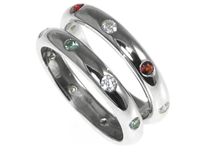 Two platinum eternity rings with garnets and alexandrite