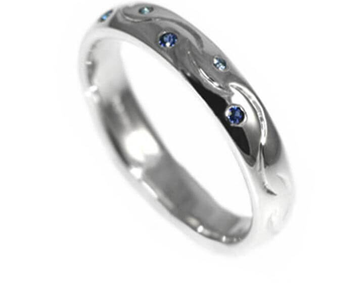 A bespoke Sterling silver and blue sapphire eternity ring 