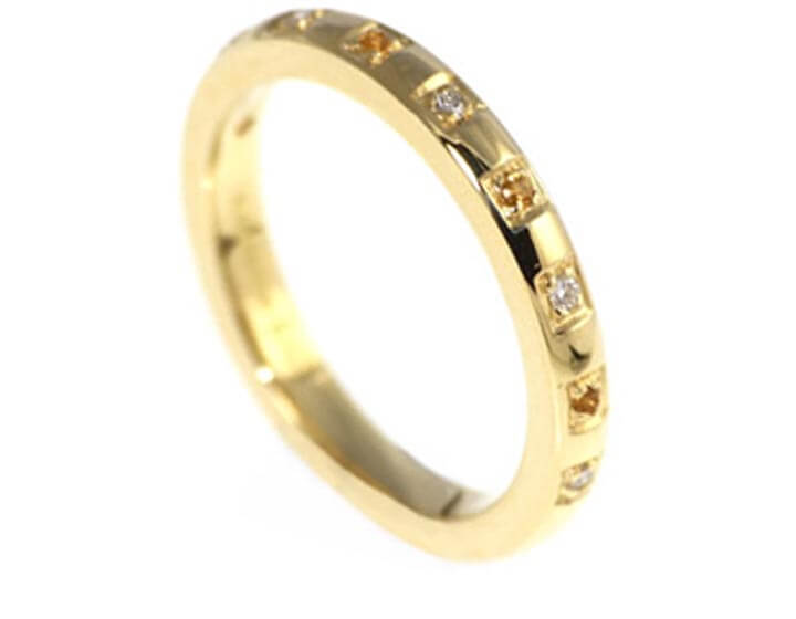 A handmade yellow gold eternity ring with citrines and diamonds