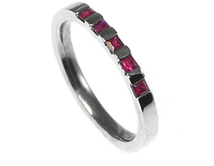 Palladium eternity ring with five princess cut rubies