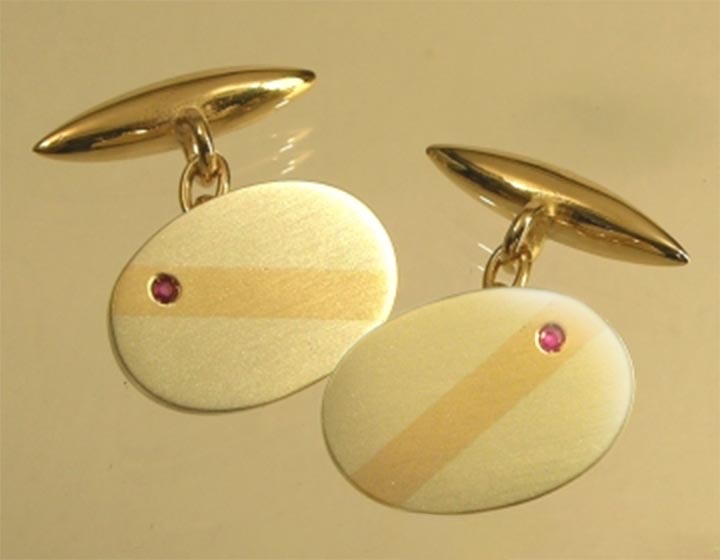 Pair of commissioned gold and ruby mixed gold colour cufflinks