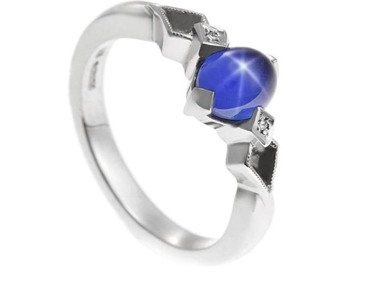 Palladium and 1.58ct oval cabochon cut star sapphire engagement ring