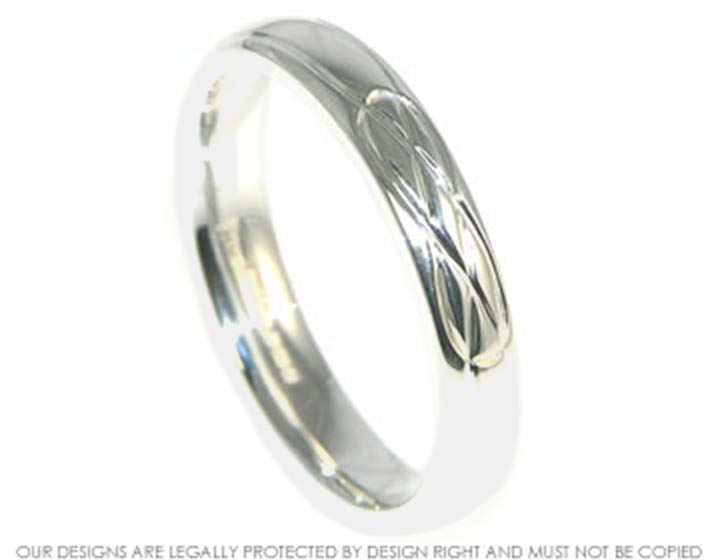 Sterling silver wedding ring with a celtic style engraving. 